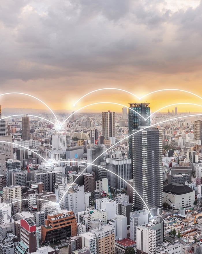 A smart city connected with IOT with connections represented with white curves