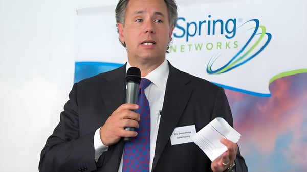 Eric Dresselhuys speaking into a microphone in front of a Silver Spring Networks banner.
