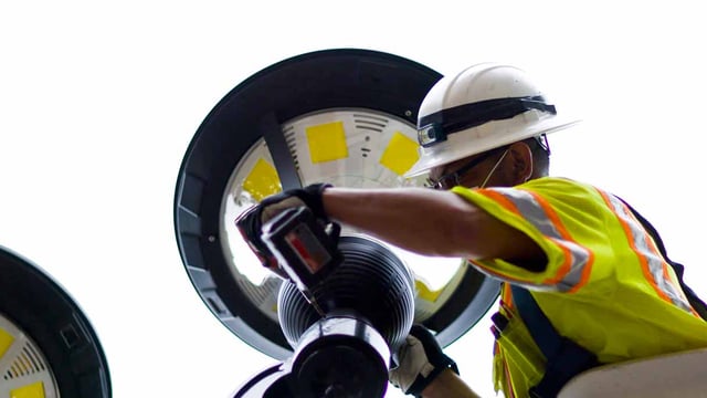 A technician installing a LED smart street light in the city of philadelphia