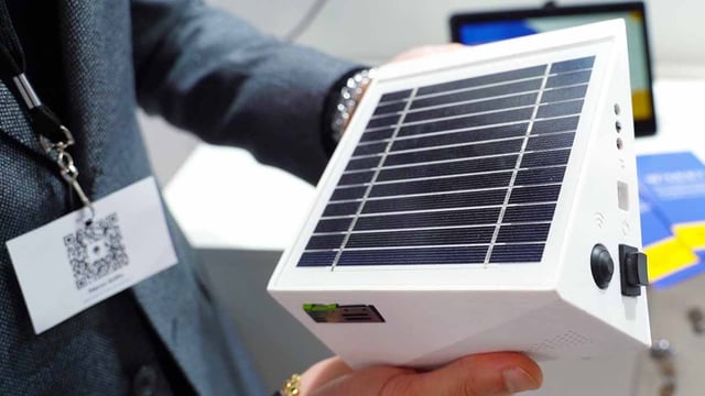 A person showing an IoT Air Quality Monitoring sensor for a Smart City.