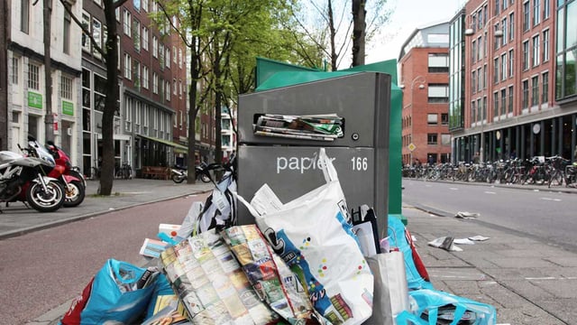 A waste bin overlflow on the street of Amsterdam that is adopting and AI Waste Solution