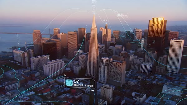 Aerial view of the San Francisco skyline at dusk with digital network lines and data overlays connecting skyscrapers.