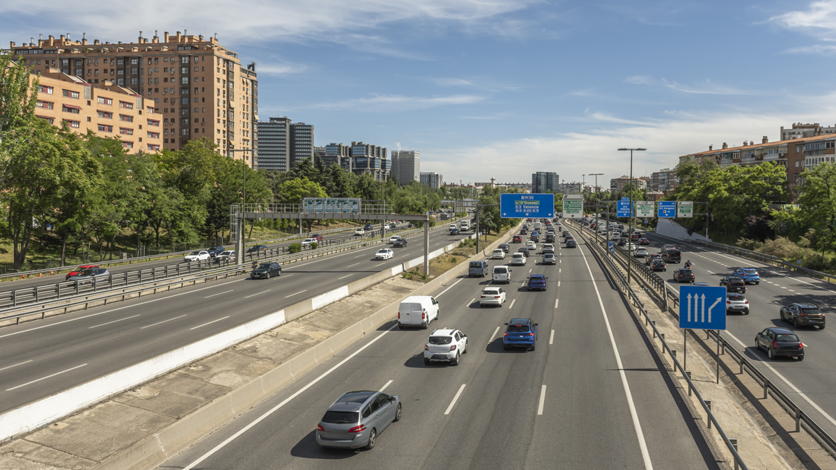overhead gantries with blue Spanish road signage