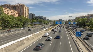 overhead gantries with blue Spanish road signage