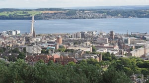 Elevated view of the Dundee city skyline and the River Tay with the Tay Road Bridge in the background