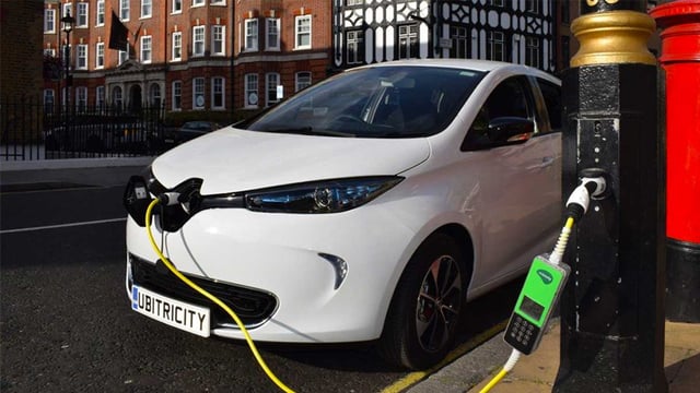 An electric car charging from a smart streetlight equipped with EV charging solution
