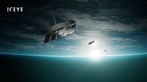 Rendering of ICEYE synthetic aperture radar satellites orbiting Earth with the sun rising over the horizon