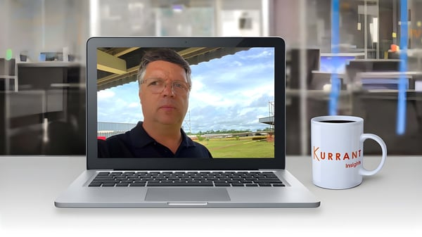 João Matos on a laptop video call next to a Kurrant Insights coffee mug in a blurred office setting.