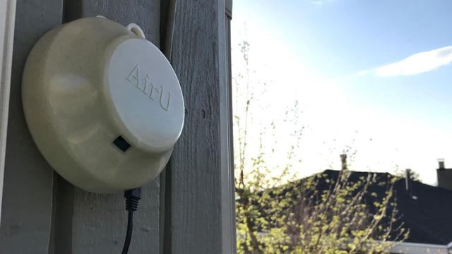 An AirU air quality sensor mounted on a wall in Kansas.