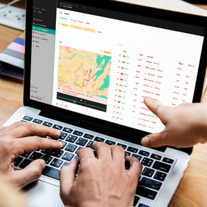 A laptop screen showing a map being used by someone for waste pickup route optimization.