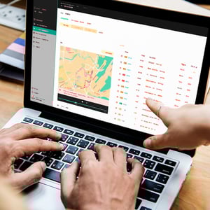 A laptop screen showing a map being used by someone for waste pickup route optimization.