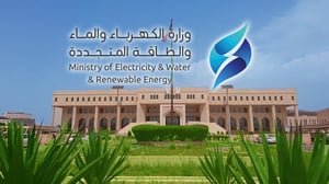Kuwait Ministry of Electricity, Water, and Renewable Energy logo overlaid on a tan government building with arched windows.