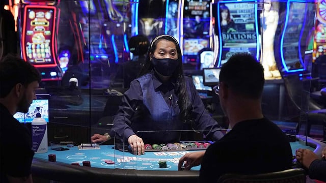 Las Vegas casino with people wearing masks as the city rethink its smart city plans.