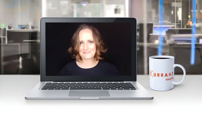 Emily Yates on a laptop screen next to a Kurrant Insights coffee mug in an office setting.