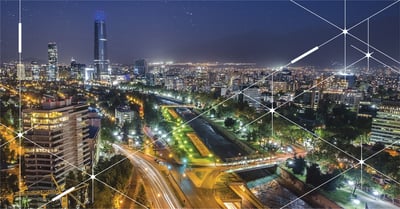 A stunning view of an illuminated smart city with tall buildings and twinkling lights.