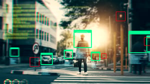 Computer vision graphics with bounding boxes and code overlay a pedestrian crossing a sunlit city