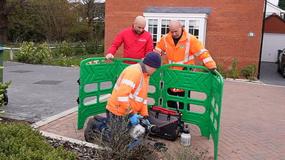 A technical team installing an AMI smart water meter