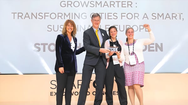 Four people on a stage holding an award in front of a GrowSmarter sign at the Smart City Expo World Congress.
