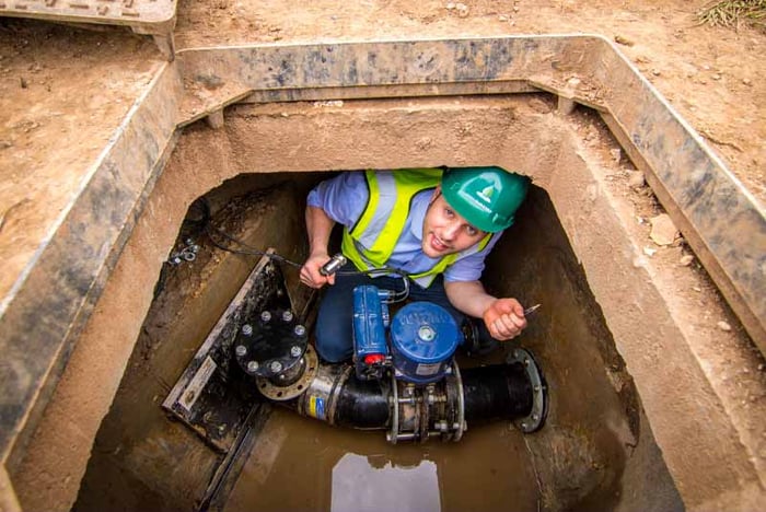 Engineer fixing a wastewater pipe