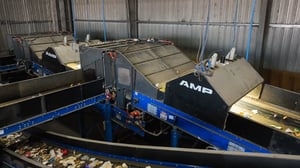AMP Robotics automated sorting systems installed over conveyor belts in a recycling facility