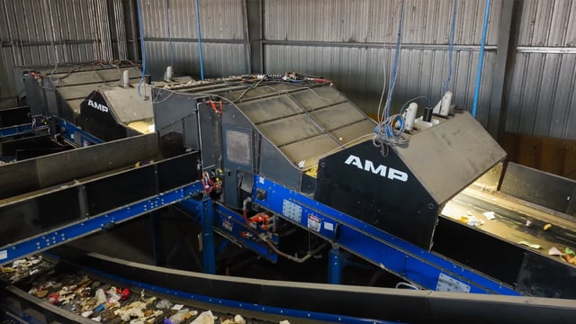 AMP Robotics automated sorting systems installed over conveyor belts in a recycling facility
