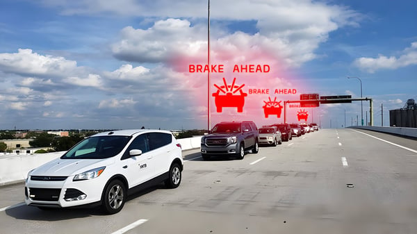 Cars on a Tampa highway with digital "BRAKE AHEAD" warning icons overlaid above the traffic lane.