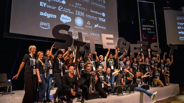 A group of city officials celebrating a victory for the smart city of Stockholm.