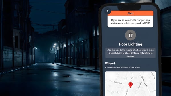 Smartphone displaying a safety app with a "Poor Lighting" report interface over a dark, dimly lit city street at night.