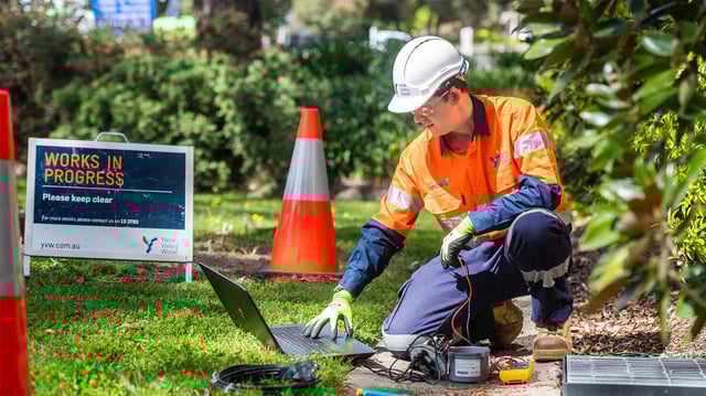 A water utility engineer installing a smart water meter