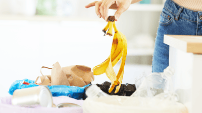 A person throwing biowaste