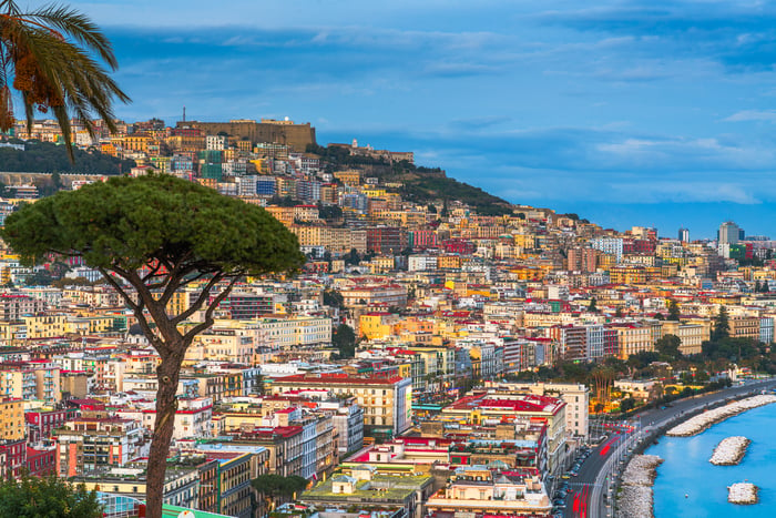 Naples, Italy along the Gulf of Naples at dusk.