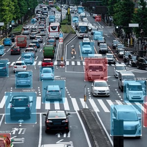 A snapshot of a city street with cars and traffic lights, analyzed by a computer vision mobility solution.