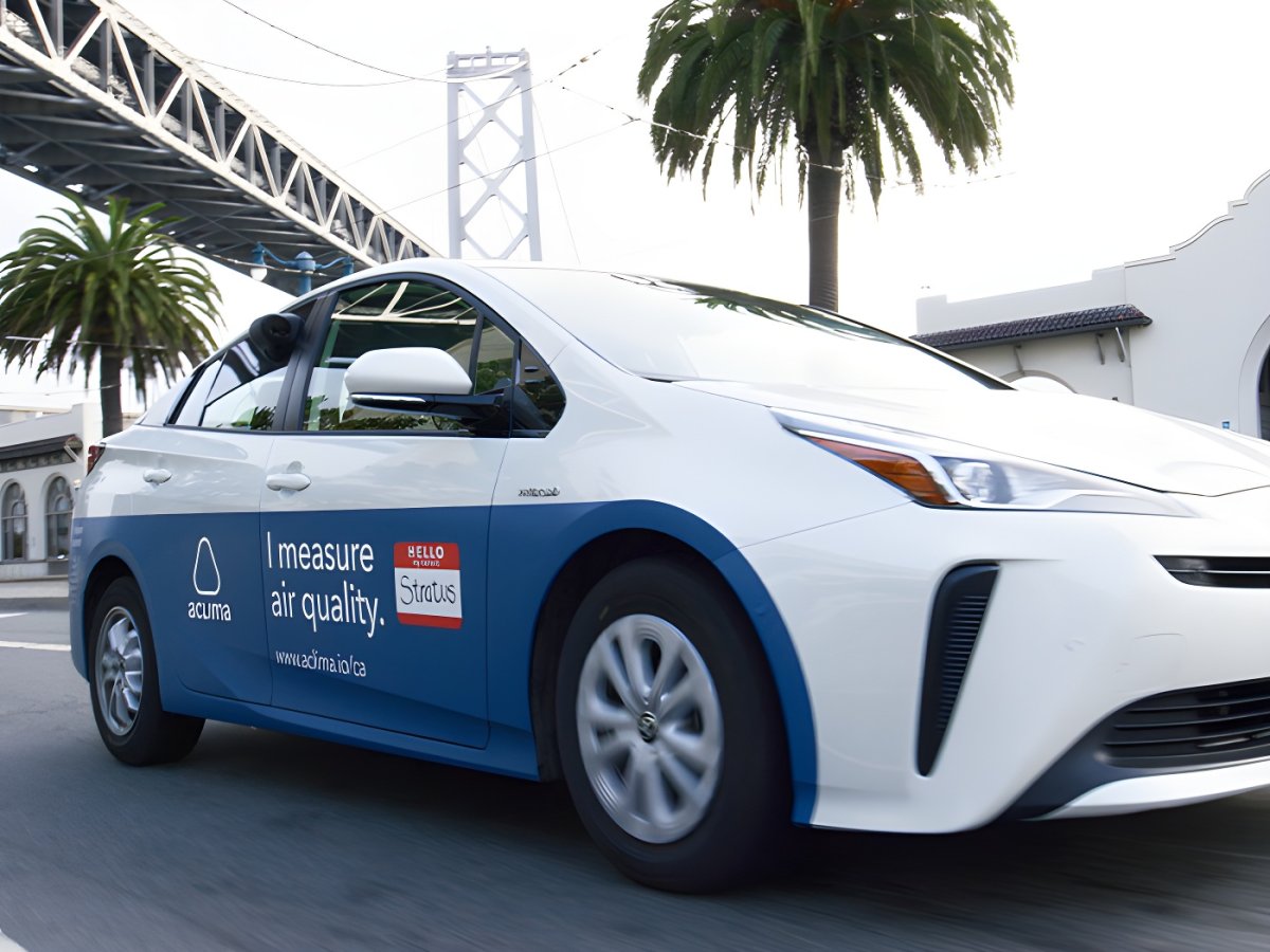 Aclima air quality monitoring vehicle driving on a city street near the San Francisco-Oakland Bay Bridge.