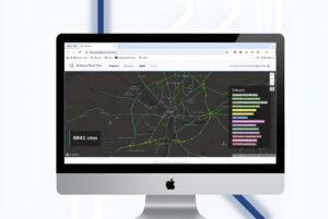 Desktop monitor displaying the Alchera Technologies data hub with a digital map of Nottingham's road network.