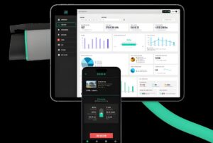AmpUp EV charging management software displayed on a tablet dashboard and smartphone app against a black background.