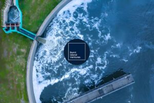 Aerial view of a circular water treatment tank with churning water and the Burnt Island Ventures logo overlaid in the center.