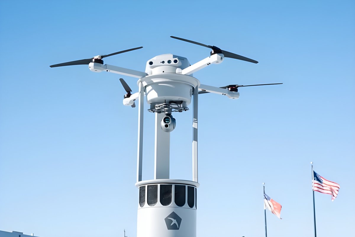 Birdstop drone with a gimbal camera lifting off from a docking station against a blue sky with American flags.