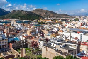 High-angle view of the Cartagena city skyline in Spain featuring dense urban buildings and surrounding mountains.
