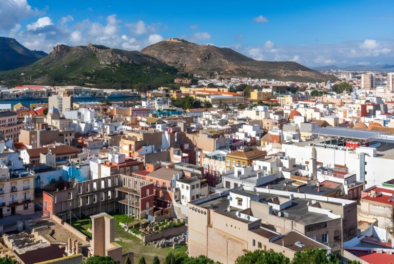 High-angle view of the Cartagena city skyline in Spain featuring dense urban buildings and surrounding mountains.