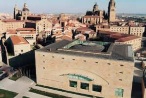 Aerial view of the Salamanca Exhibition and Congress Center with the historic city skyline and cathedral in the background.