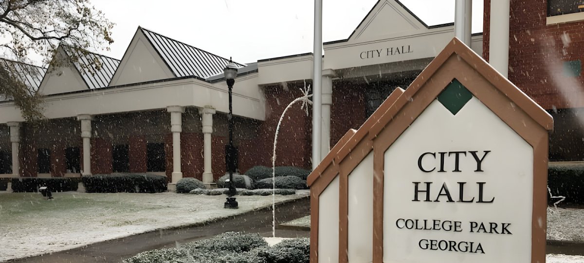 College Park Georgia City Hall building and monument sign during a light snowfall.