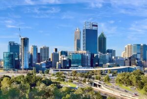 Skyline of Perth, Australia, featuring the Central Park tower and Rio Tinto building overlooking a highway and parkland.