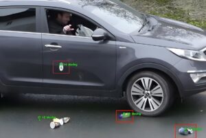LitterCam AI software interface tracking a driver throwing trash from a grey SUV with green bounding boxes around debris.