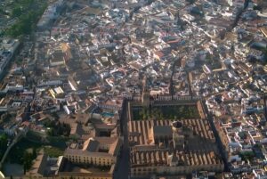 Aerial view of the Mosque-Cathedral of Córdoba and the surrounding dense urban landscape of Córdoba, Spain.