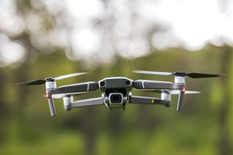 DJI Mavic 2 Pro quadcopter drone hovering in mid-air against a blurred green forest background.