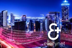 Everynet logo and binary data streams overlaid on a night skyline of illuminated skyscrapers and city infrastructure.
