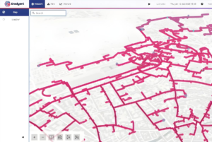 Gradyent software interface displaying a pink digital twin network map of district heating pipes over a city layout.
