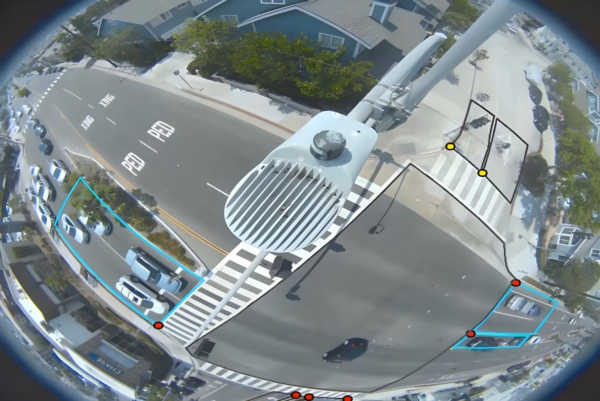 Fisheye view from a smart traffic camera monitoring an intersection with digital bounding boxes around vehicles.