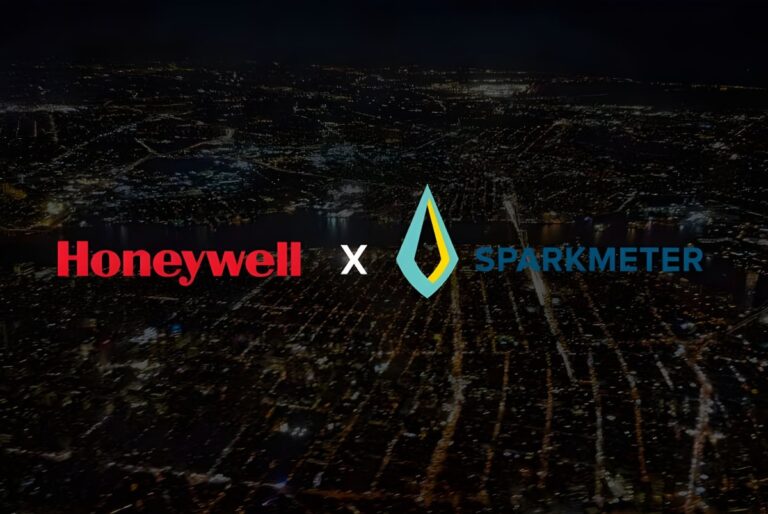Honeywell and SparkMeter logos overlaid on an aerial view of a city grid at night with illuminated streets.