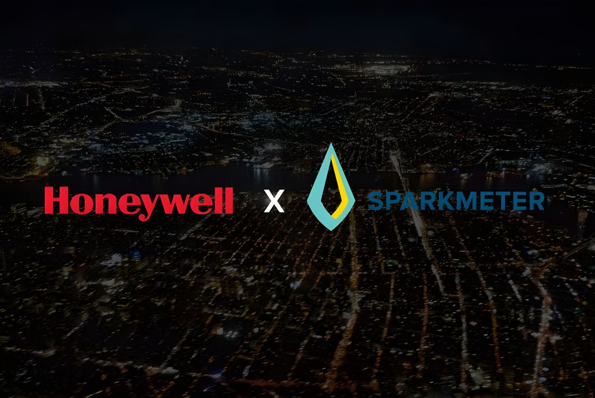 Honeywell and SparkMeter logos overlaid on an aerial view of a city grid at night with illuminated streets.